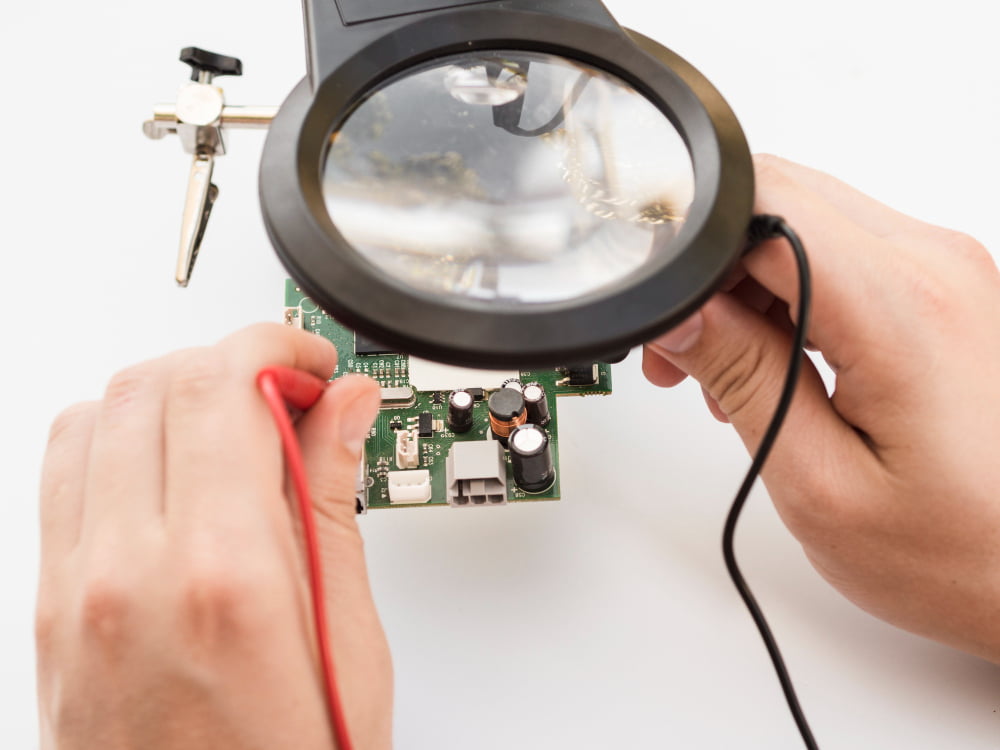 man-using-multimeter-check-board